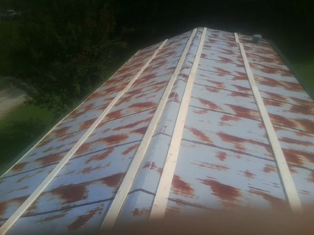 Rusted metal roof panels with new wood purlins before replacement — Storm Damage Roof Repair in Van Etten by Roofing Brothers