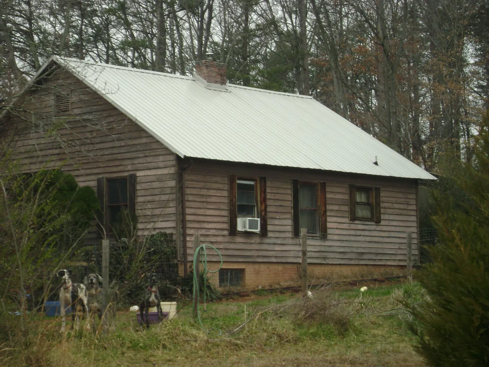 White metal roof on an old wood sided farmhouse, from a Metal Roof Installation job in Van Etten